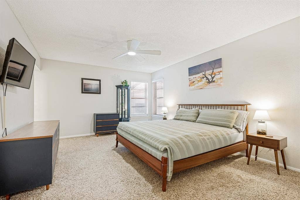 404 Green River Trail, Fort Worth, TX 76103 Carpeted room featuring a ceiling fan, window with blinds, and white walls