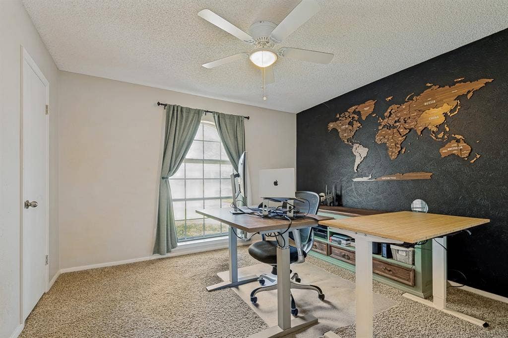 404 Green River Trail, Fort Worth, TX 76103 Room featuring carpet flooring, a multi-pane window with drapes, and a ceiling fan with integrated lighting