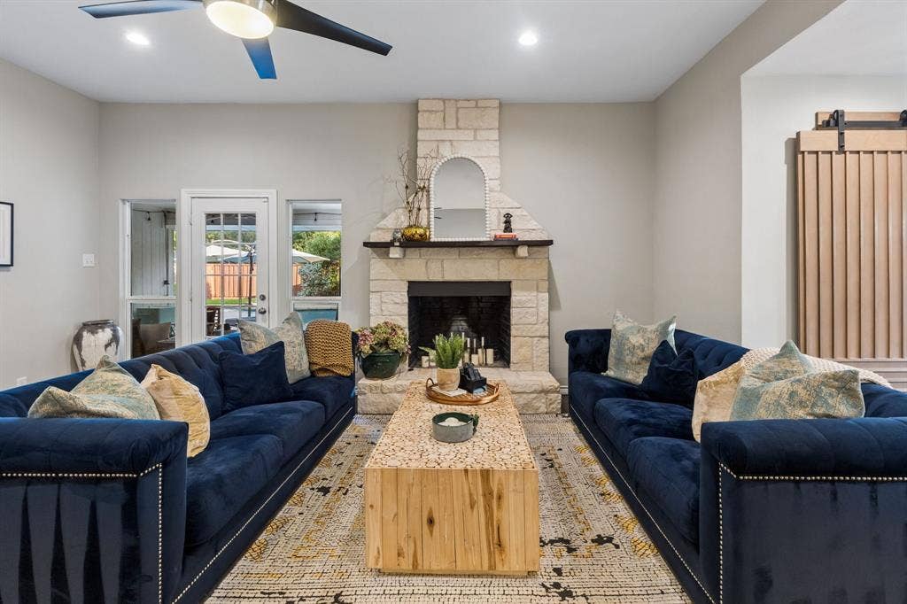 6708 McCallum Boulevard, Dallas, TX 75252 Central stone fireplace with a substantial hearth and mantel