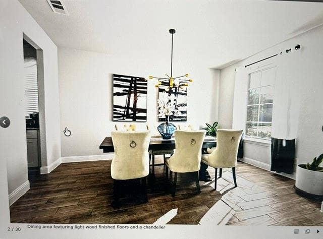 4220 Calla Drive, Forney, TX 75126 Dining area featuring wood-finish flooring, a modern chandelier, and ample natural light from a large window