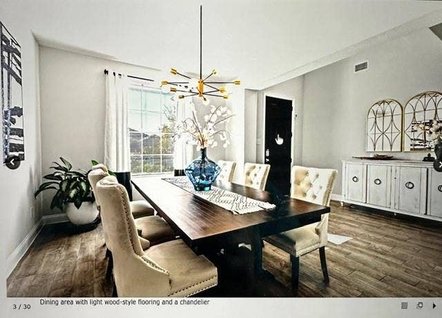 4220 Calla Drive, Forney, TX 75126 Dining area featuring wood-finish flooring, a contemporary chandelier, a window with white curtains, and light-toned walls