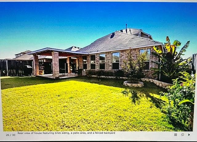 4220 Calla Drive, Forney, TX 75126 Spacious backyard featuring a covered patio, brick siding, a manicured lawn, and perimeter fencing