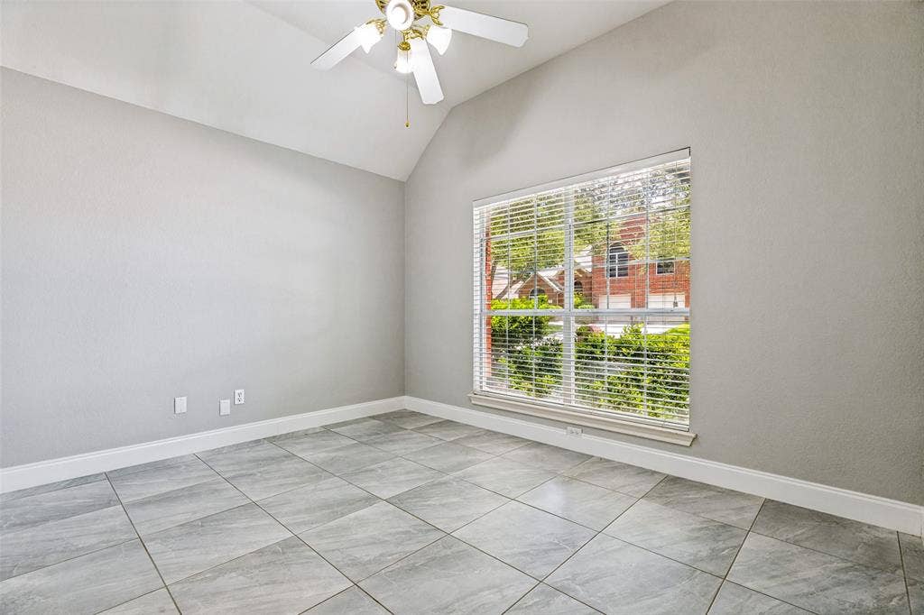 110 Falcon Creek Drive, McKinney, TX 75072 Interior room featuring light gray tile flooring, a large window with horizontal blinds, and a white ceiling fan with a light kit