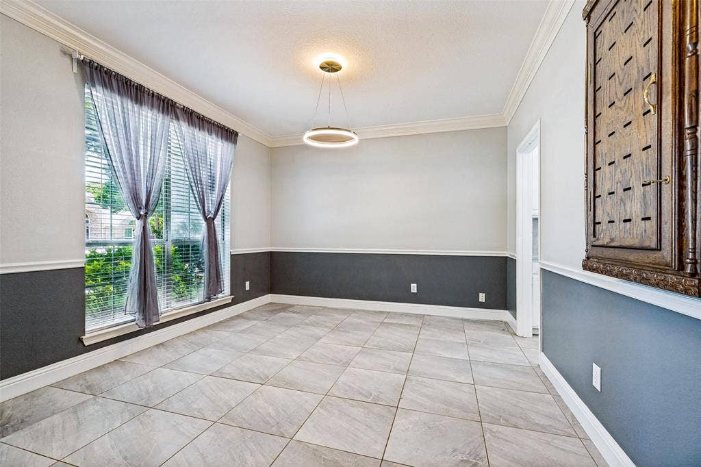 110 Falcon Creek Drive, McKinney, TX 75072 Neutral-toned large format tile flooring complements the two-tone wall treatment with chair rail molding