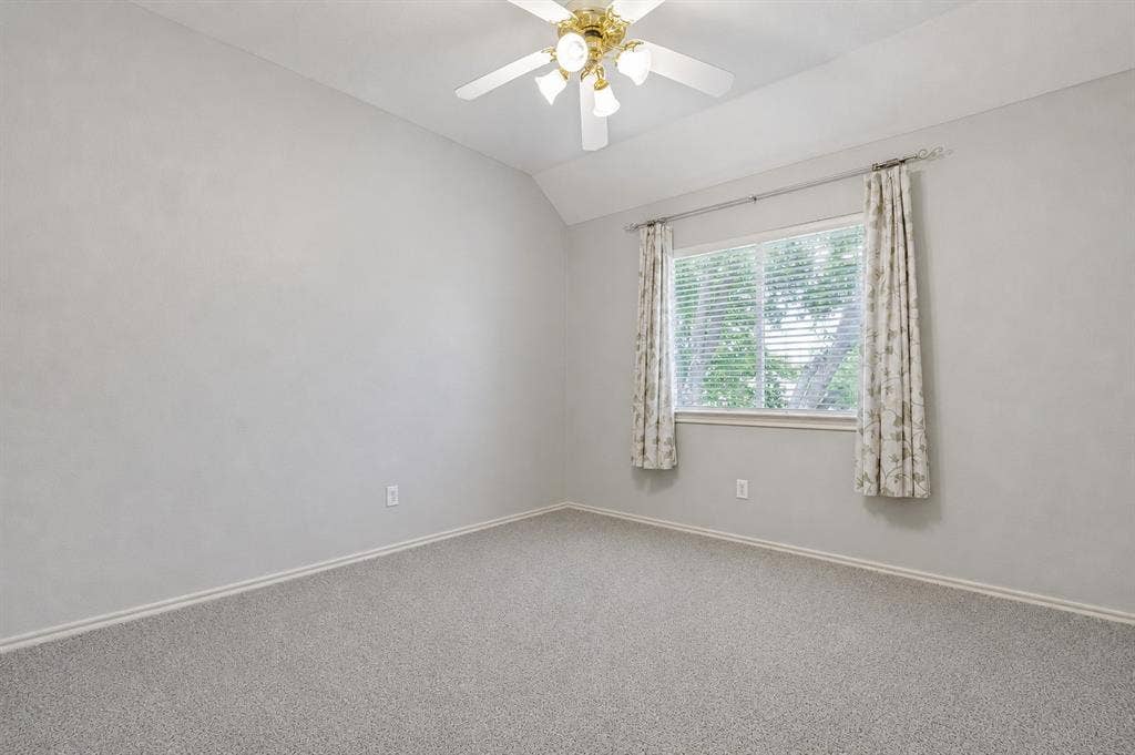 110 Falcon Creek Drive, McKinney, TX 75072 Carpeted room featuring a single window with blinds and drapes, a ceiling fan with integrated lighting, and neutral wall tones
