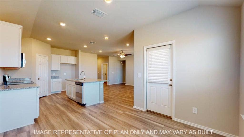 10325 Altair Drive, Waco, TX 76708 Kitchen featuring an island with sink, white cabinetry, speckled countertops, and wood-finish flooring
