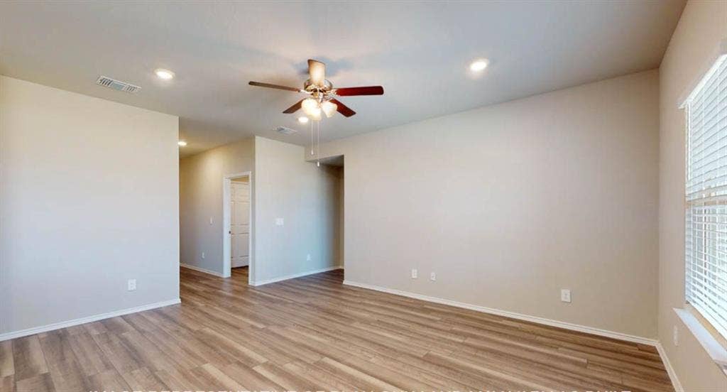 10325 Altair Drive, Waco, TX 76708 Spacious room with wood-finish flooring, light neutral wall paint, white trim, a ceiling fan, and recessed lighting