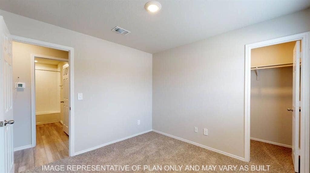 10325 Altair Drive, Waco, TX 76708 Neutral tone wall paint, carpet flooring, recessed lighting, and a built-in closet with shelving and hanging rod