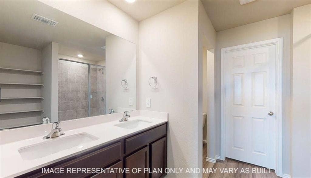 10325 Altair Drive, Waco, TX 76708 Dual vanity with undermount sinks, chrome fixtures, and a white countertop
