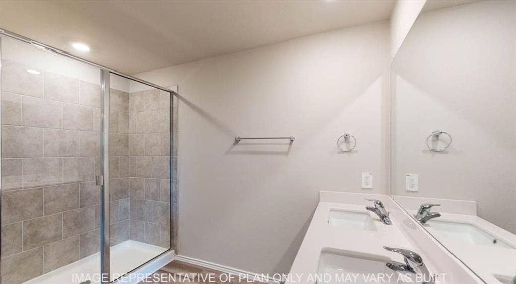 10317 Altair Drive, Waco, TX 76708 Shower with glass enclosure and neutral-toned rectangular tile surround