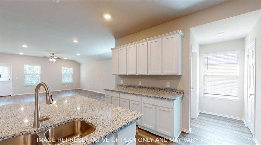 10317 Altair Drive, Waco, TX 76708 Kitchen island with granite countertop and stainless steel sink