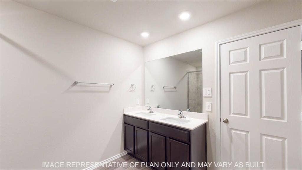 10317 Altair Drive, Waco, TX 76708 Dual vanity with dark wood-finish cabinetry, white countertop, and integrated sinks