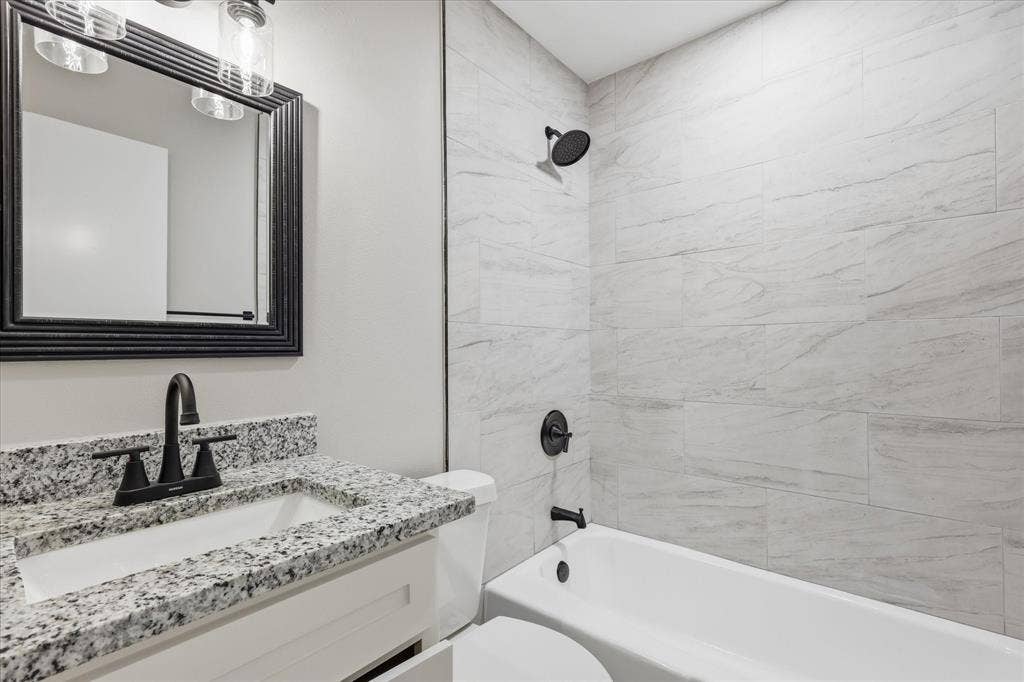 857 Twilight Trail, Grapevine, TX 76051 Bathroom featuring a white vanity with granite-style countertop, undermount sink, and matte black faucet