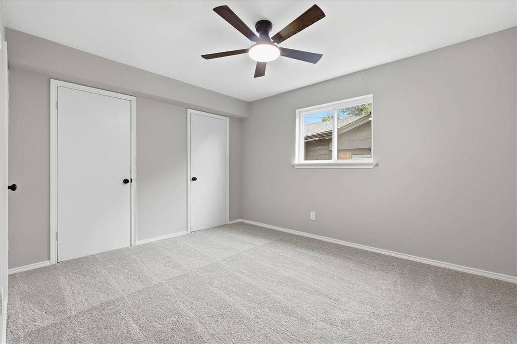 857 Twilight Trail, Grapevine, TX 76051 Spacious room featuring light gray wall paint, light-toned carpet flooring, a window with exterior views, and a ceiling fan with integrated lighting