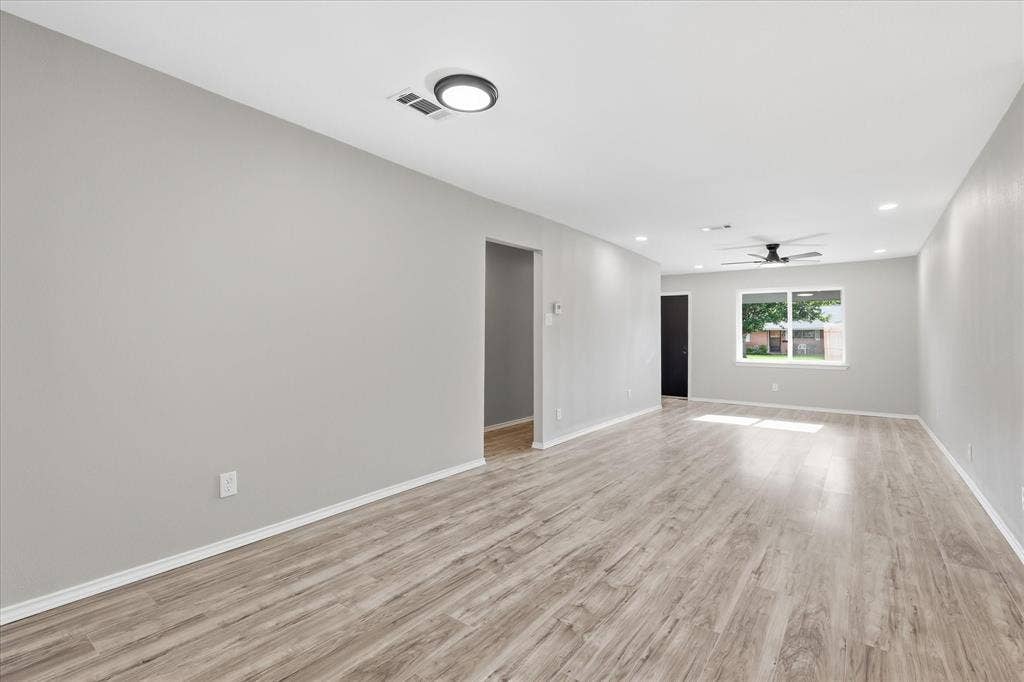 857 Twilight Trail, Grapevine, TX 76051 Spacious room featuring wood-finish flooring, light gray walls, and white baseboards