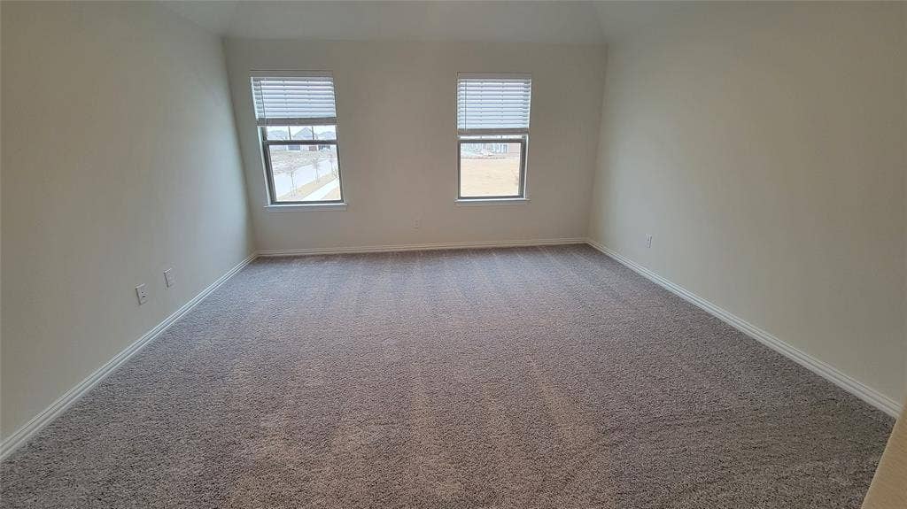 11346 Sugarlands Drive, Frisco, TX 75035 Spacious room featuring neutral wall paint, two windows with blinds, and light gray carpeting