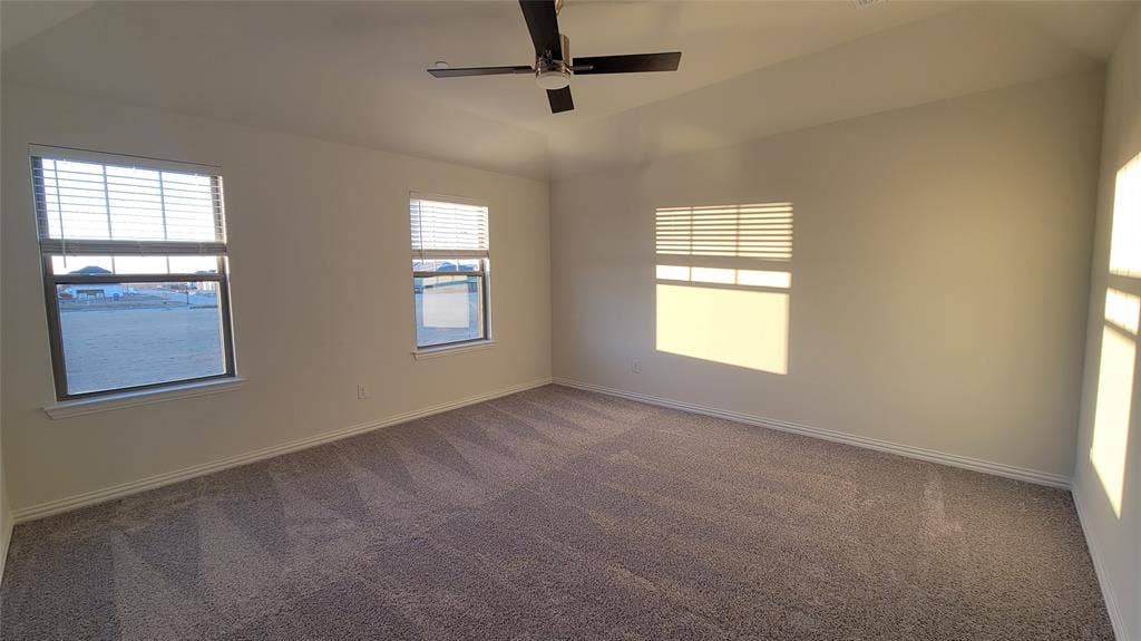 11346 Sugarlands Drive, Frisco, TX 75035 Spacious room featuring vaulted ceilings, neutral-toned walls, and plush carpeting