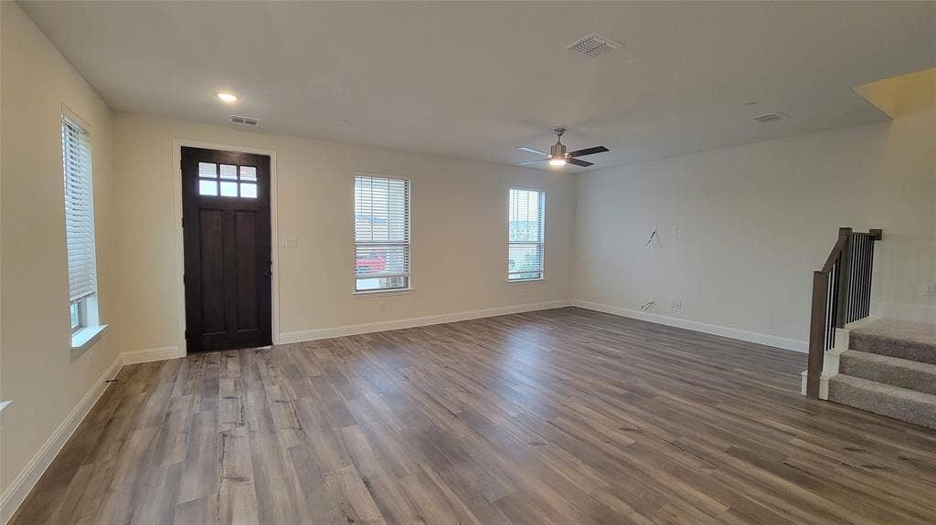 11346 Sugarlands Drive, Frisco, TX 75035 Open-concept living space featuring wood-finish flooring, recessed lighting, and a modern ceiling fan