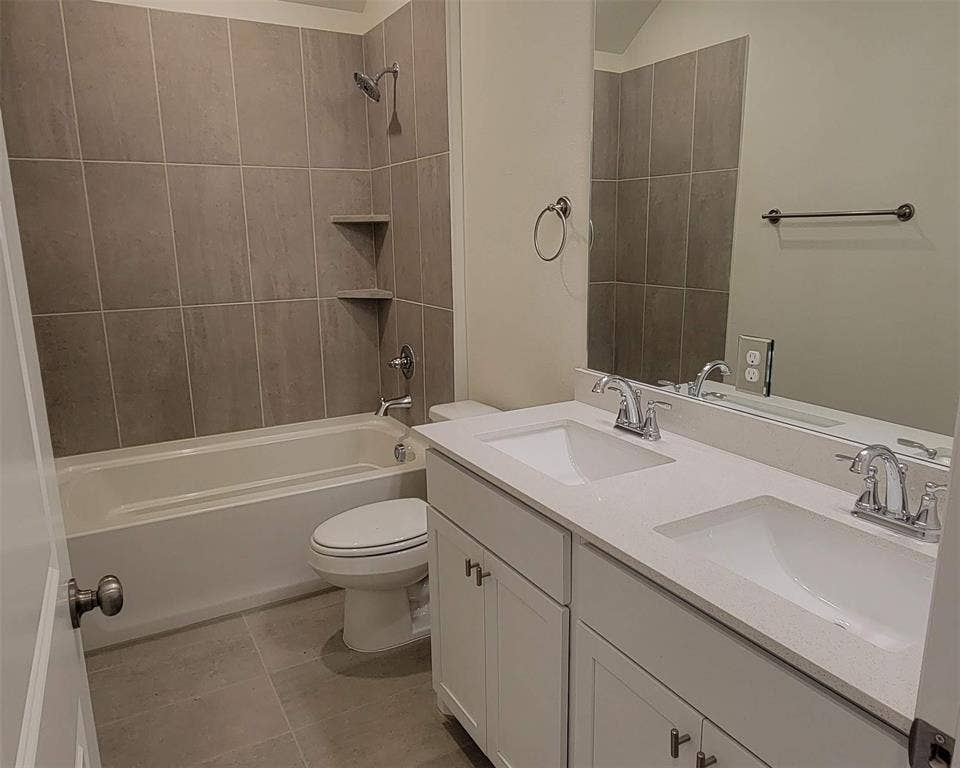 11346 Sugarlands Drive, Frisco, TX 75035 Bathroom with dual vanity featuring built-in sinks, a solid surface countertop, and white shaker-style cabinetry