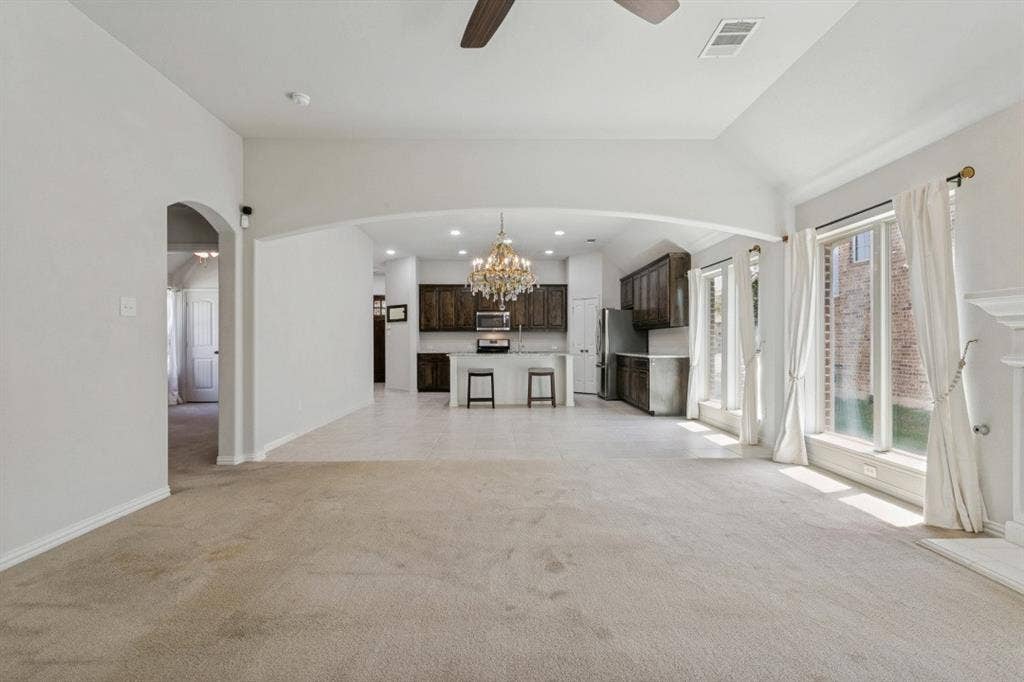 Open-concept living space featuring vaulted ceilings and recessed lighting
