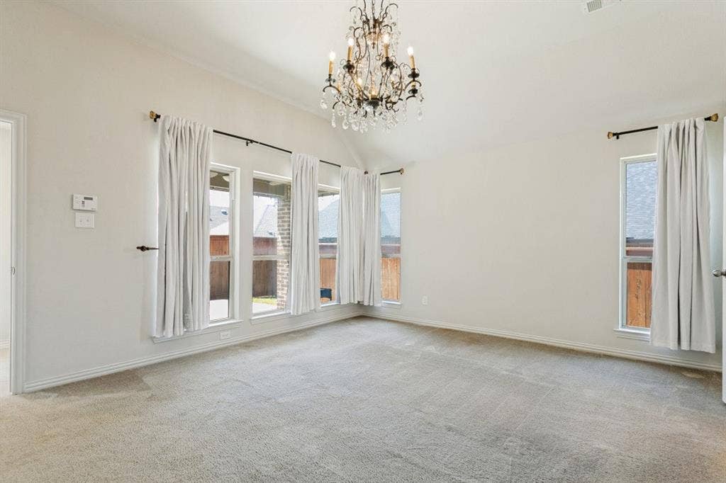 Large primary bedroom with tons of light from the floor to ceiling windows