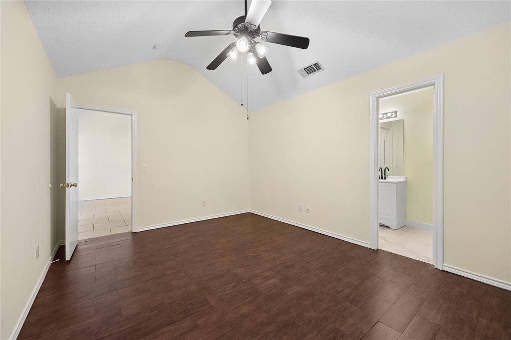 113 Bridlegate Drive, McKinney, TX 75069 Vaulted ceiling featuring a central multi-light fan, dark wood-finish flooring, and neutral wall tones