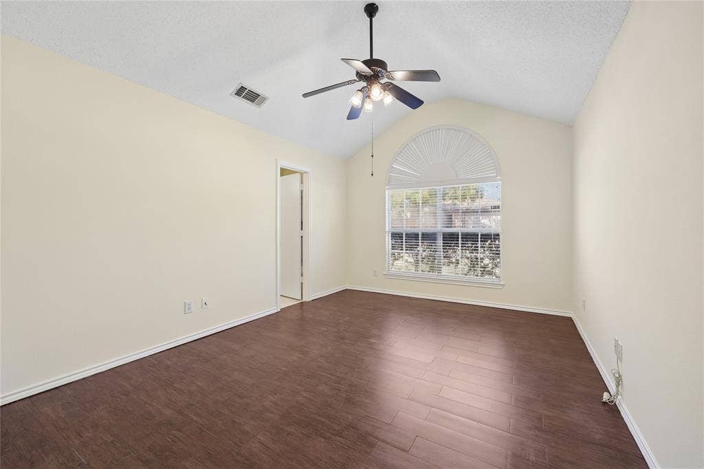 113 Bridlegate Drive, McKinney, TX 75069 Vaulted ceiling, wood-finish flooring, and arched window featuring a half-moon transom