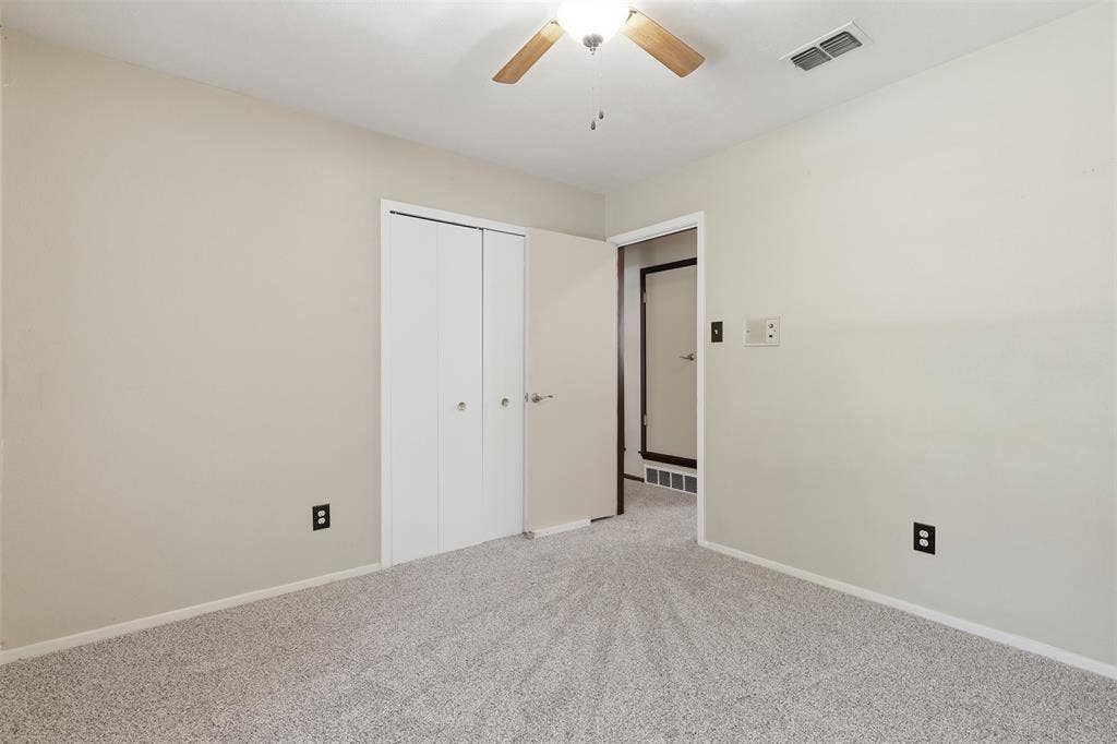 3702 Hastings Drive, Arlington, TX 76013 Bedroom #2 - Bright secondary bedroom with new carpet installed July 2026, ceiling fan, neutral paint, and natural light in this Arlington, TX 76013 home