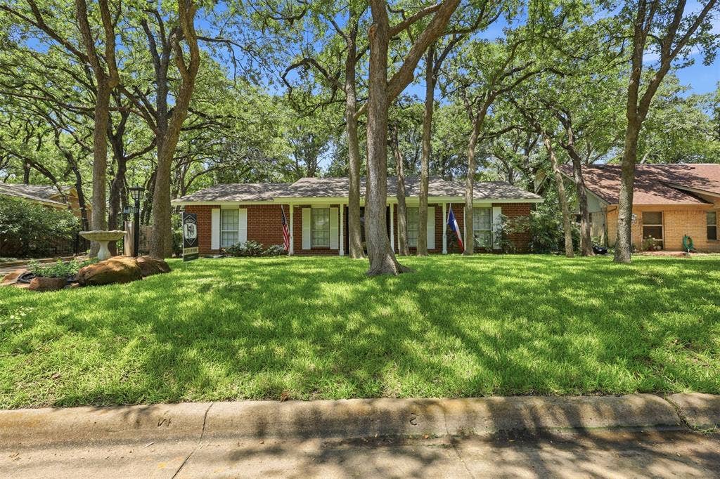 3702 Hastings Drive, Arlington, TX 76013 Single-story Arlington home with attractive curb appeal, a heavily treed lot, green lawn, and an established Woodland West neighborhood setting