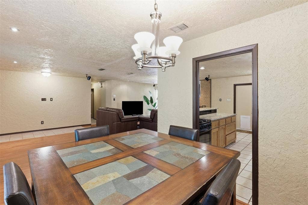 3702 Hastings Drive, Arlington, TX 76013 Flexible dining area with wood flooring and convenient access to the kitchen and open living spaces—ideal for dining, entertaining, or a home workspace