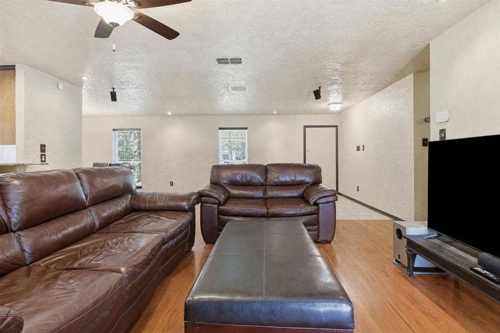 3702 Hastings Drive, Arlington, TX 76013 Large living area with wood floors, multiple windows, recessed lighting, and flexible space for entertaining or everyday living