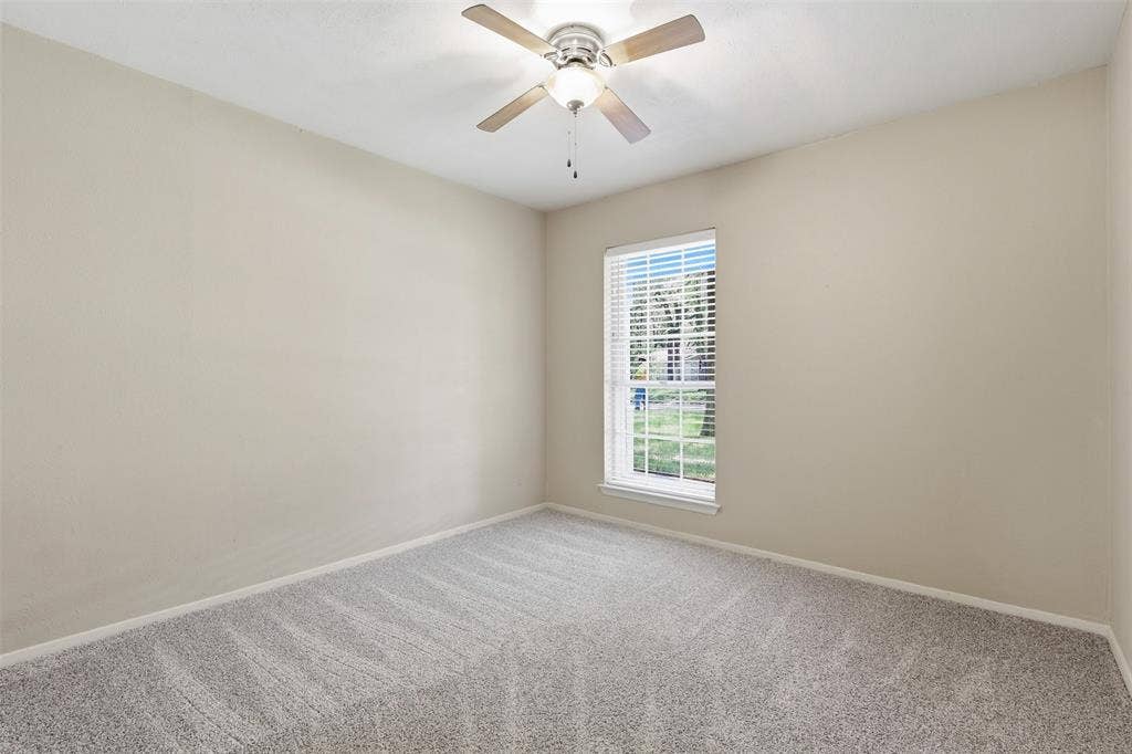 3702 Hastings Drive, Arlington, TX 76013 Bedroom #2 - Bright secondary bedroom with new carpet installed July 2026, ceiling fan, neutral paint, and natural light in this Arlington, TX 76013 home
