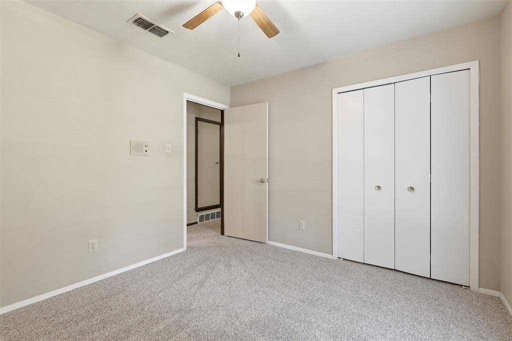 3702 Hastings Drive, Arlington, TX 76013 Bedroom #3 - Bright secondary bedroom with new carpet installed July 2026, neutral paint, ceiling fan, and natural light in this Arlington, TX 76013 home