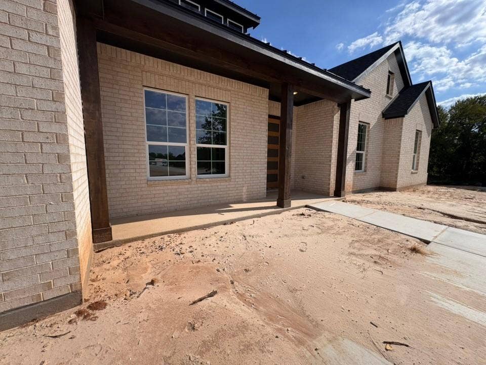 809 Zachary Michael Court, Springtown, TX 76082 Brick exterior with dark trim and a prominent covered entry