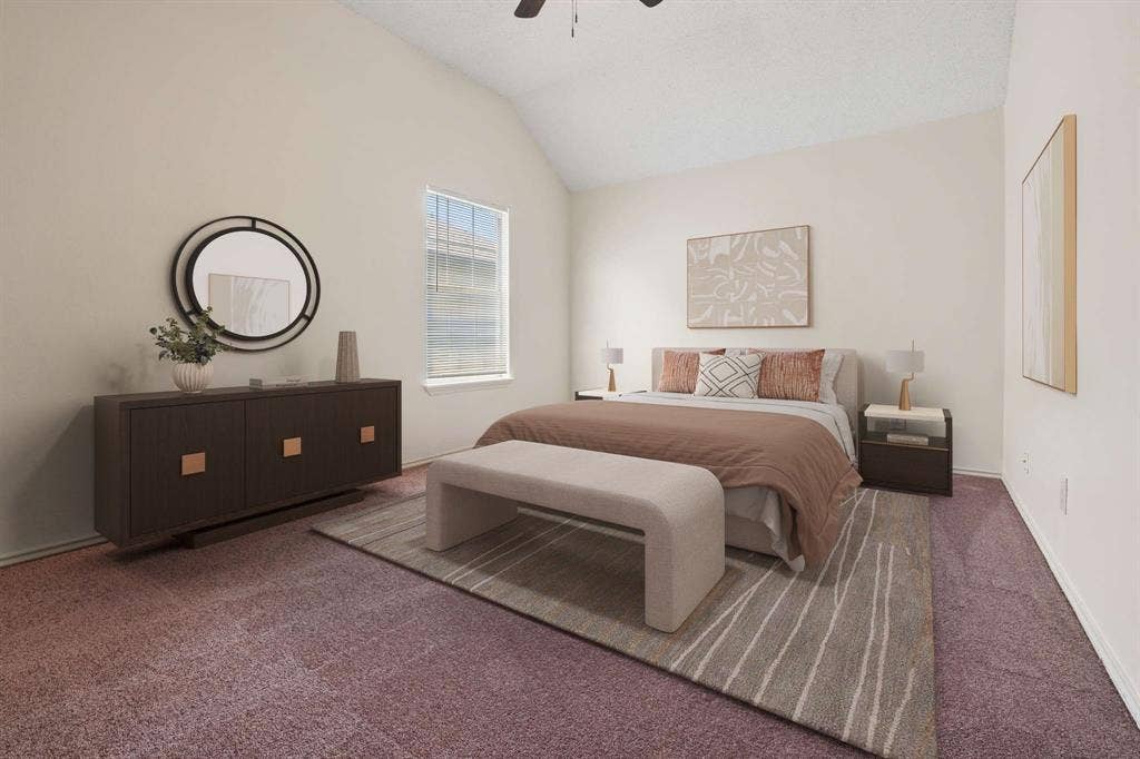 Spacious room featuring vaulted ceilings, a window with blinds, and soft carpet flooring