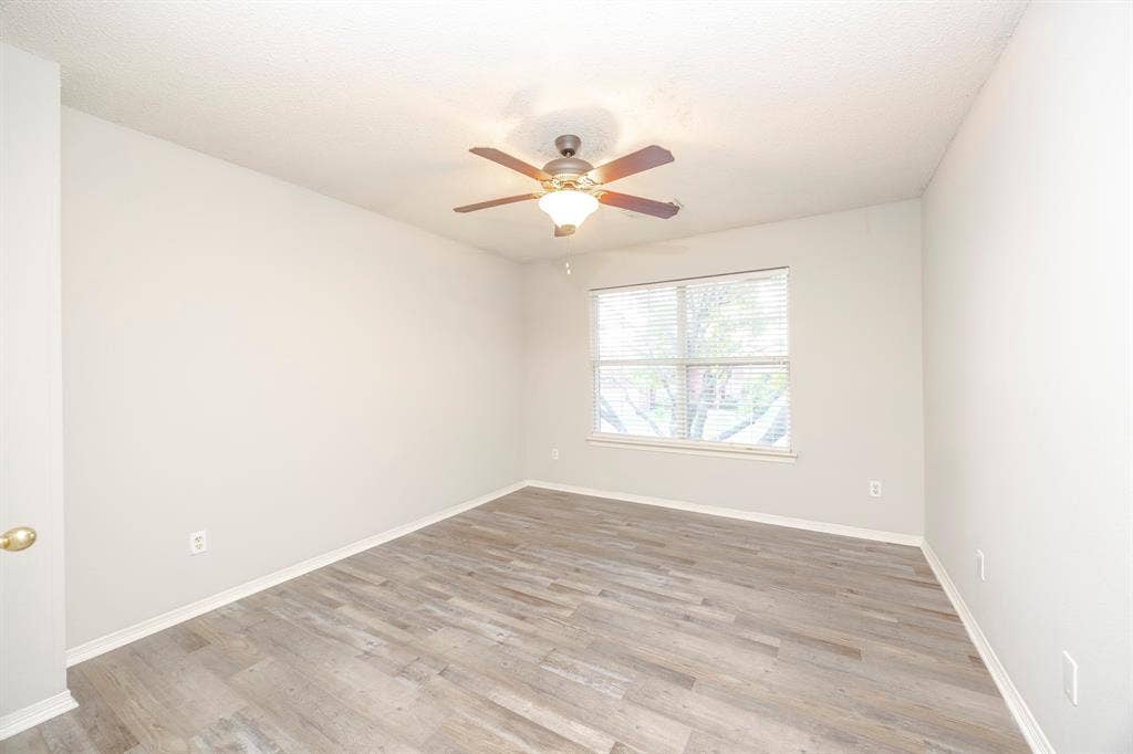 12475 Cajun Drive, Frisco, TX 75035 Wood-finish flooring, ceiling fan with integrated lighting, and a window with blinds