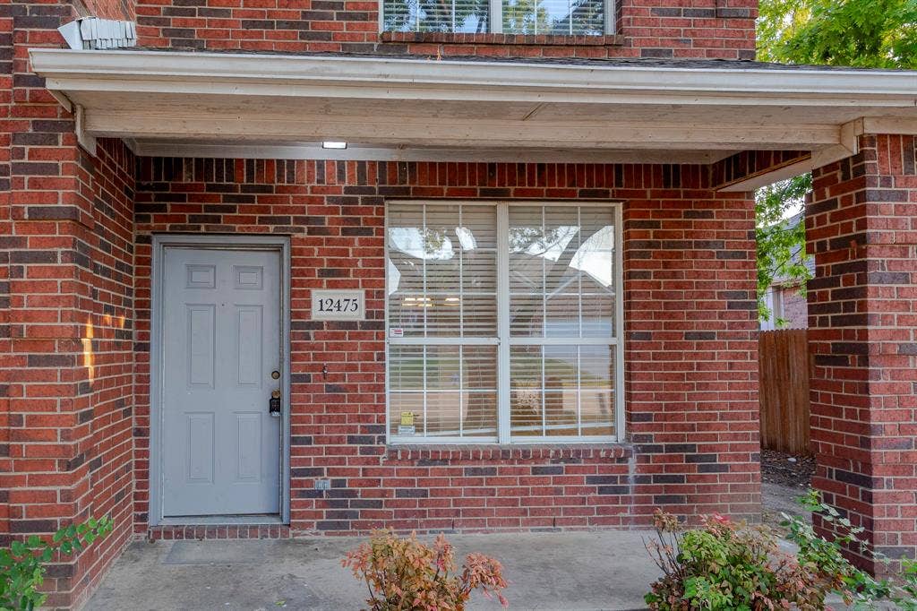 12475 Cajun Drive, Frisco, TX 75035 Brick exterior with a covered entry