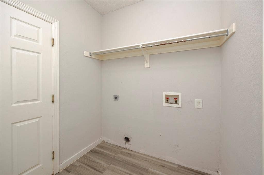 12475 Cajun Drive, Frisco, TX 75035 Wood-finish flooring, white paneled door, and built-in shelving