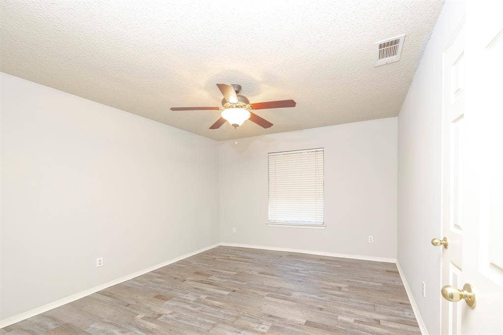 12475 Cajun Drive, Frisco, TX 75035 Wood-finish flooring, ceiling fan with integrated lighting, and window with blinds