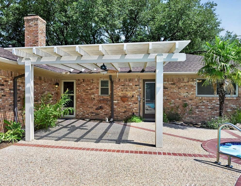 3310 Raintree Drive, Plano, TX 75074 Covered pergola offers a shaded outdoor living area overlooking the pool and spa, and beautifully landscaped backyard