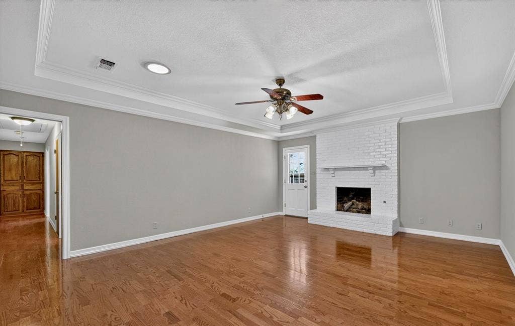 3310 Raintree Drive, Plano, TX 75074 Spacious living room with matching architectural ceiling details, and wood/gas log fireplace