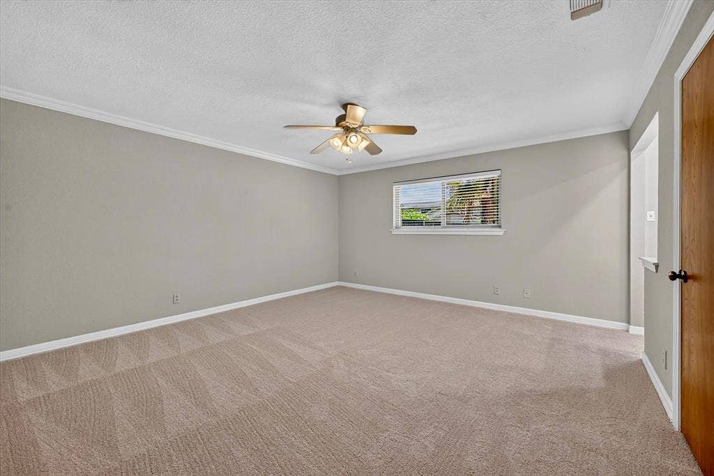 3310 Raintree Drive, Plano, TX 75074 Spacious primary suite with fresh carpet, ceiling fan, and private ensuite bath