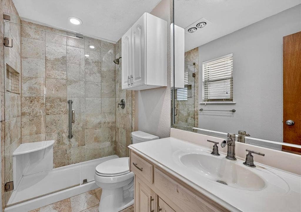 3310 Raintree Drive, Plano, TX 75074 Updated primary bath featuring an oversized walk-in shower, custom tile, and abundant storage