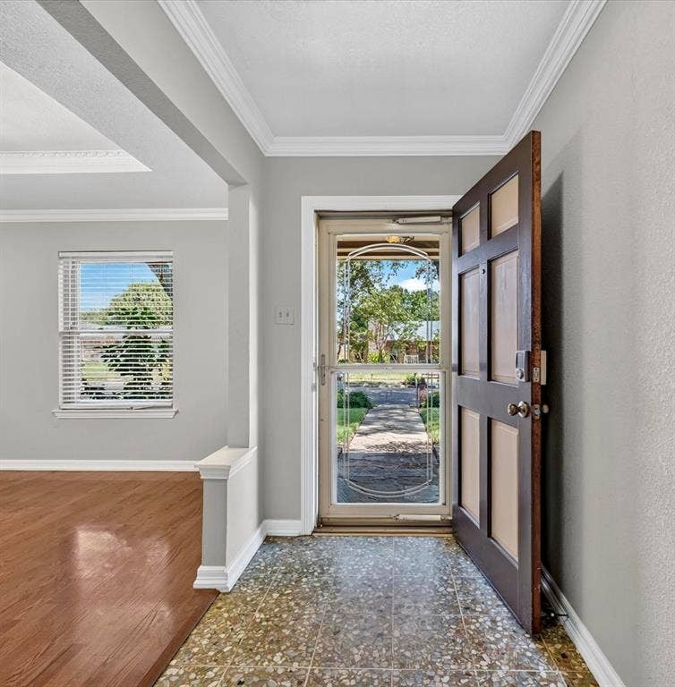 3310 Raintree Drive, Plano, TX 75074 Welcoming entry with a heavy glass front door, Terrazzo tile, and rich wood flooring