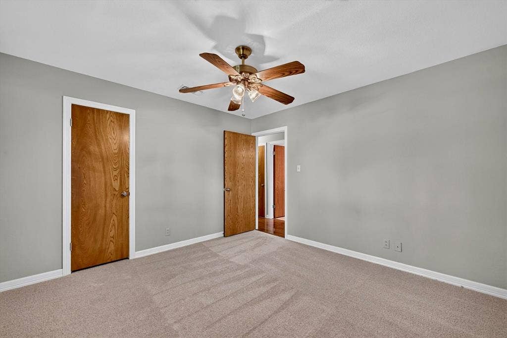 3310 Raintree Drive, Plano, TX 75074 Generously sized secondary bedroom with fresh carpet, ceiling fan, and large closet.