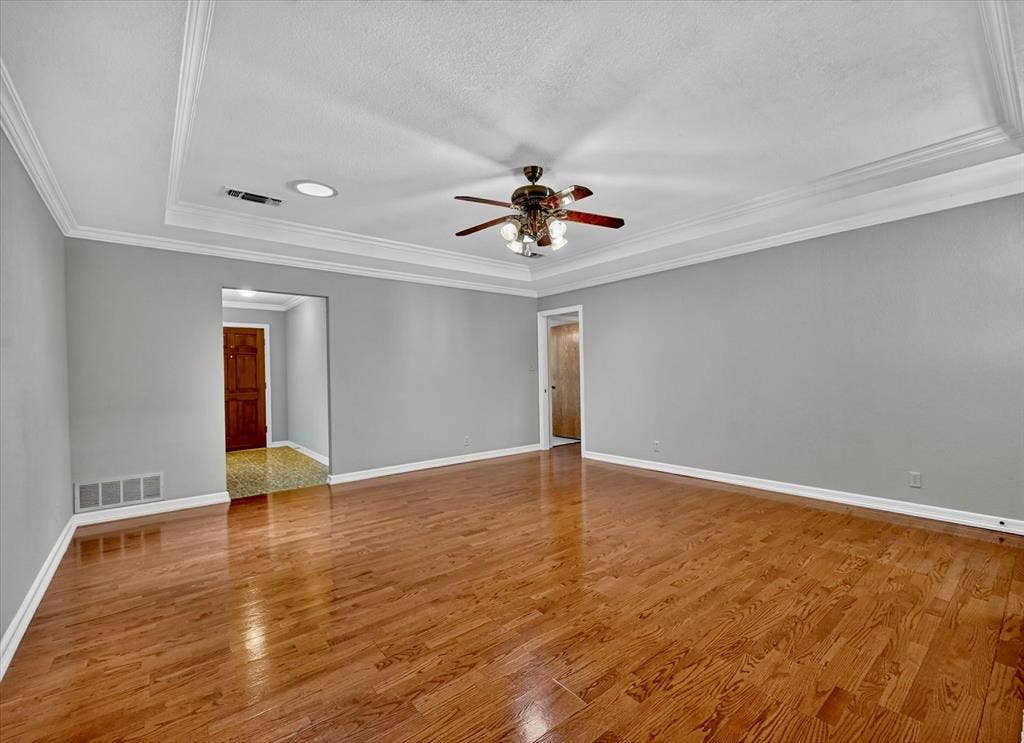 3310 Raintree Drive, Plano, TX 75074 Living room with two ceiling lights for natural light and entries to front and bedroom hallways