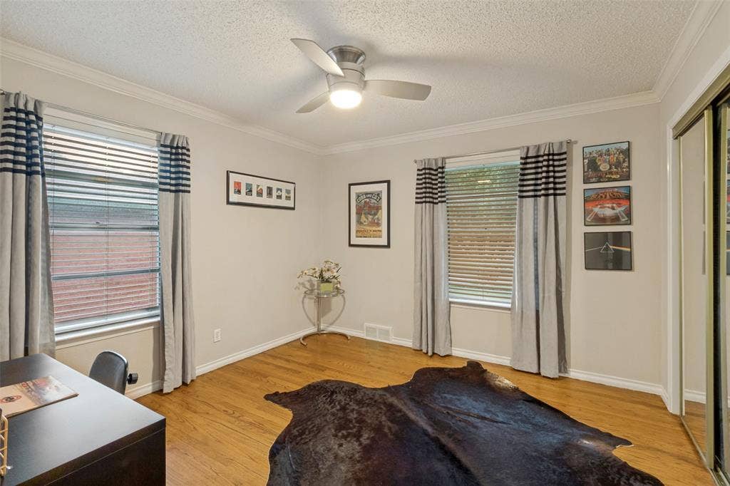 second bedroom with natural light and hardwoods