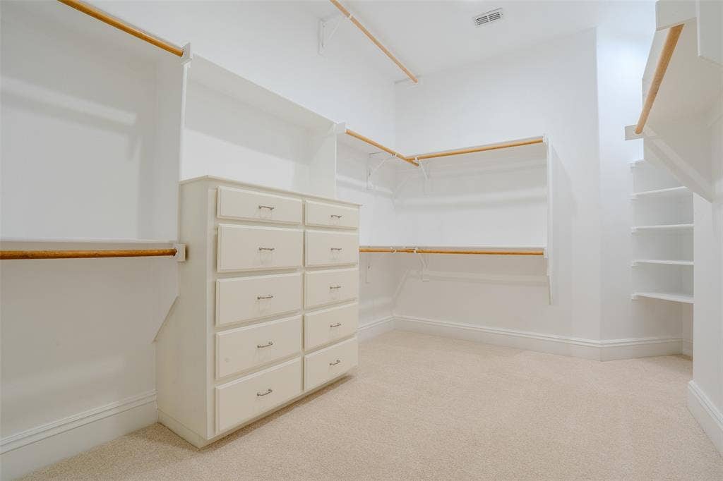 710 Corsica Court, Argyle, TX 76226 large primary closet with plenty of shelving and built in dresser