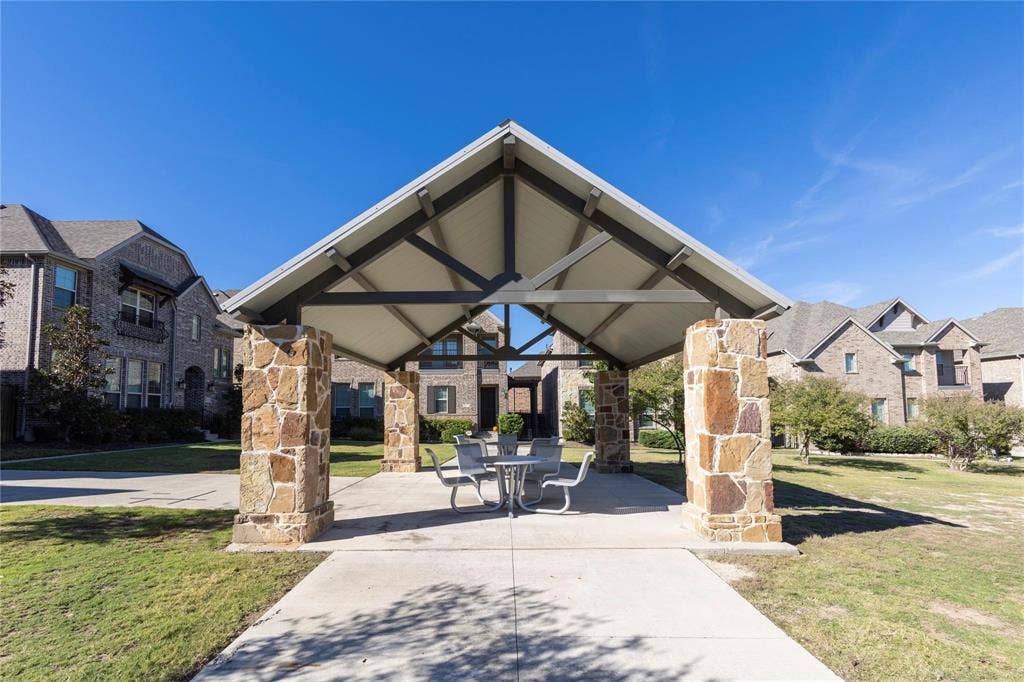 2455 Cathedral Drive, Richardson, TX 75080 Outdoor pavilion with stone-clad pillars in front of the property.