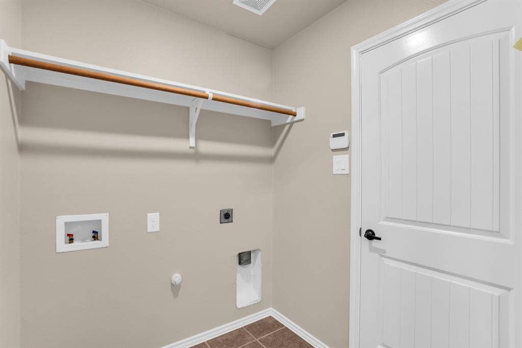 805 Andrews Court, Anna, TX 75409 Dedicated utility space with durable tile flooring that leads to garage.